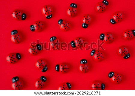 Red ladybugs toy on a red background. Cute and amazing ladybugs.