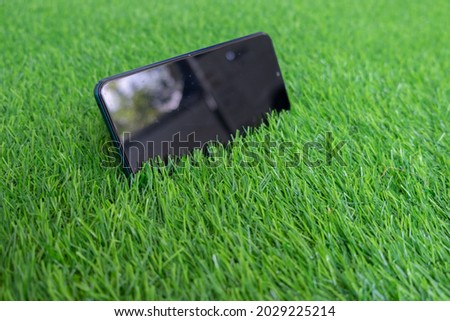 mobile phone set aside on the grass