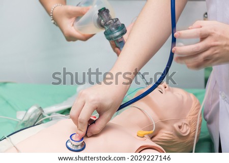 CPR training medical procedure - Demonstrating chest compressions on CPR doll in the class Royalty-Free Stock Photo #2029227146