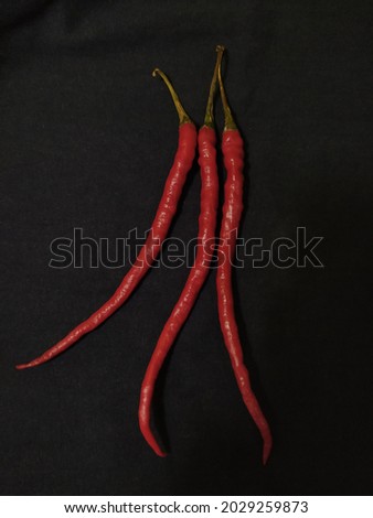 black background,. Red chili is one of the spices in cooking.