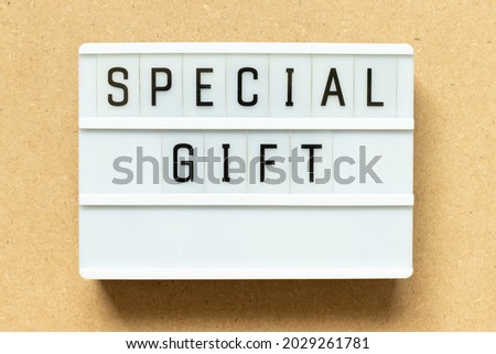 Lightbox with word special gift on wood background