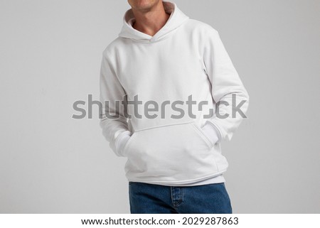 Young male in blank white hoodie front view. Design men  sweatshirt with pocket template and mock-up for branding or print. Royalty-Free Stock Photo #2029287863