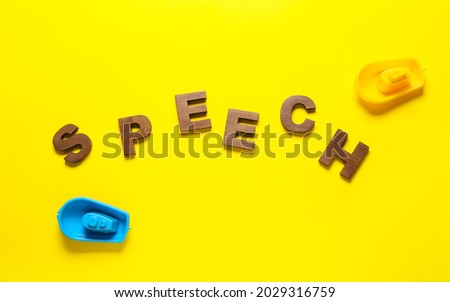 Word SPEECH and toys on color background