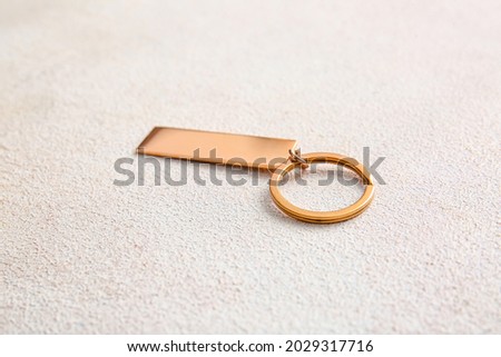 Stylish keychain on light background