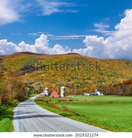 Farm with red barn and silos at sunny autumn day in West Arlington, Vermont, USA