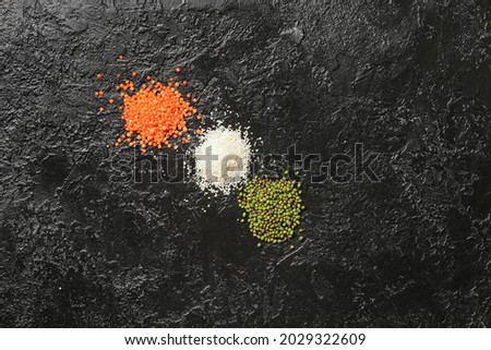 Dry food in colors of Indian flag on dark background