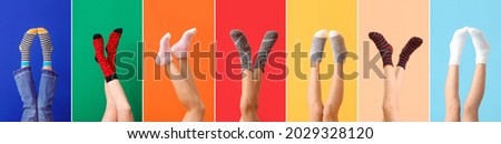Legs of young woman in socks on color background Royalty-Free Stock Photo #2029328120