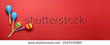 Mexican maracas on color background with space for text