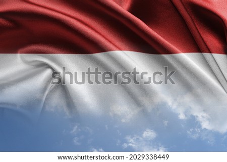 National flag of Indonesia with cloudy sky