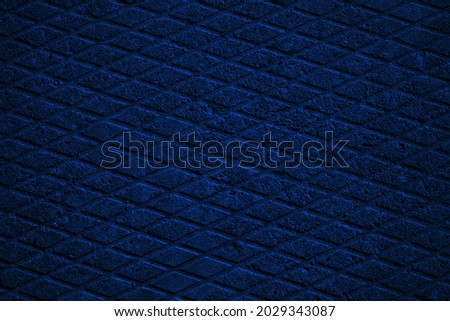  Dark blue abstract background. Toned old concrete tile. Small geometric pattern. Navy blue background with copy space for design.                              