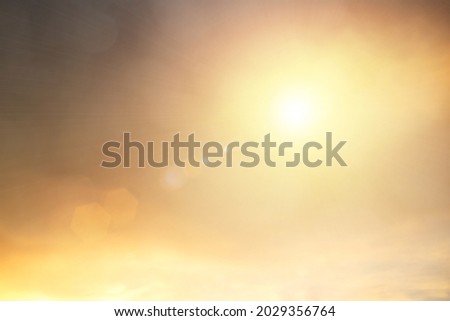 Natural background blurring warm colors and bright sun light. Bokeh or Christmas background Green Energy at sky sunny color orange light patterns plain abstract flare evening clouds blur.