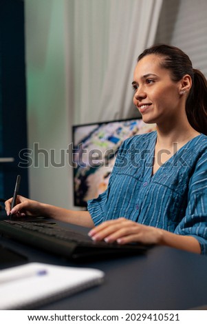Portrait of woman photographer working on design with digital tablet and stylus for editor work at office studio. Template artist doing photo editing on image with modern equipment