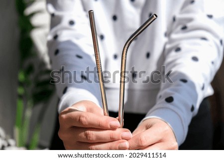 Woman holding Reusable Metal Straw. Female Hand on reusable collapsible drinking straw. Eco lifestyle and zero waste concept. Plastic free. Stainless metal straws Royalty-Free Stock Photo #2029411514