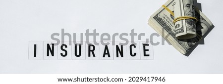 Text INSURANCE around US dollar banknotes. Health, life, home, car Insurance. Insurance business concept. Business budget of wealth and prosperity finance. Health care or medicare insurance 