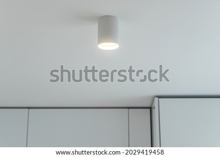 Close-up of white lamp on ceiling in kitchen. Modern interior of apartment. Royalty-Free Stock Photo #2029419458