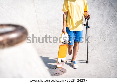 amputated skater spending time at the skatepark. concept about disability and sports