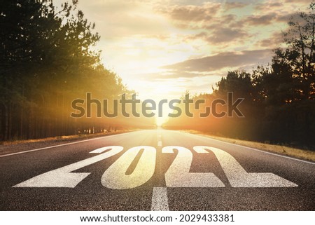 Start new year with fresh vision and ideas. 2022 numbers on asphalt road Royalty-Free Stock Photo #2029433381