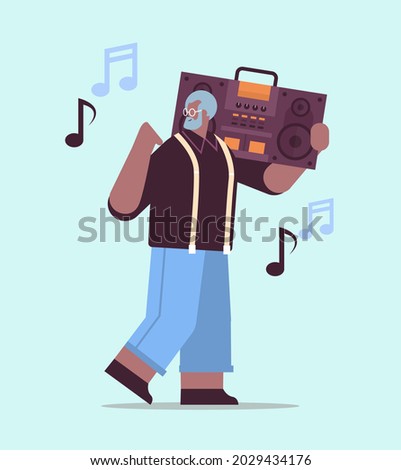 senior african american man with bass clipping ghetto blaster recorder listening music grandfather having fun