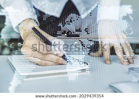 Abstract creative digital world map and hand writing in diary on background with laptop, globalization concept. Multiexposure