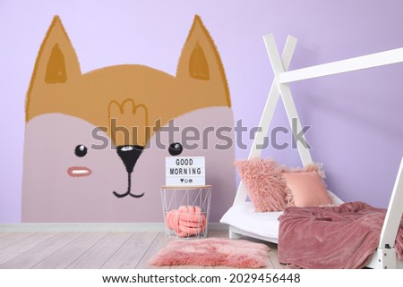 Interior of modern children's room with comfortable bed and painting of cute fox on wall