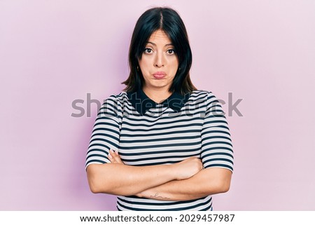 Young hispanic woman with arms crossed gesture depressed and worry for distress, crying angry and afraid. sad expression. 