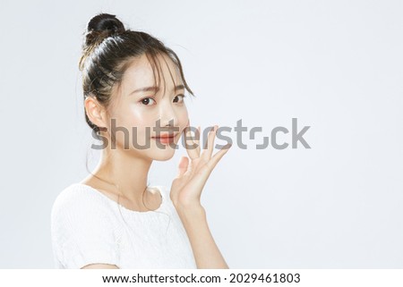 Beauty portrait of a young Asian woman with bun hair