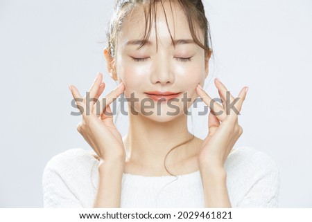 Beauty portrait of a young Asian woman with bun hair Royalty-Free Stock Photo #2029461821
