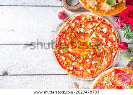 Christmas decorated pizza. Set of Various Homemade Pizza with Xmas Decoration - Cheesy Snowflakes, Christmas Tree Slices and Pepperoni Stars, with decor and baubles, copy space top view