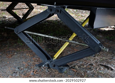 Brace under a camping trailer called an outrigger extended and on the ground Royalty-Free Stock Photo #2029502927