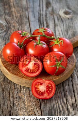 fresh ripe bunch tomatoes on wood background Royalty-Free Stock Photo #2029519508