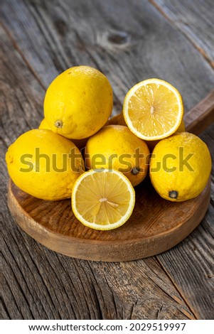 fresh ripe lemons on wood background