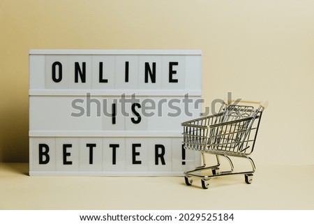 Online is better sign, commercial shot, e-commerce concept, shop cart with a pastel yellow background, copy space and minimal styling