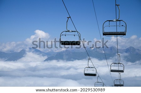 French ski resort. Chair lift in clouds. Royalty-Free Stock Photo #2029530989