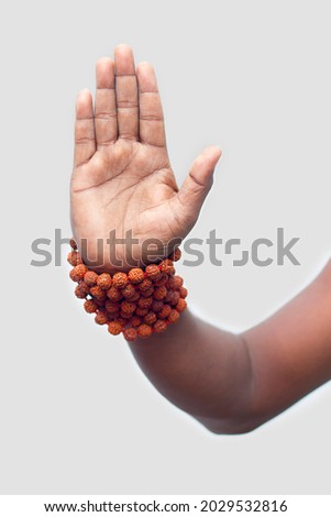 a persist showing his hand with rudraksha beads,for blessing. Royalty-Free Stock Photo #2029532816