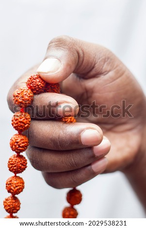 selective focus of a chanting hand with rudraksha beads. Royalty-Free Stock Photo #2029538231
