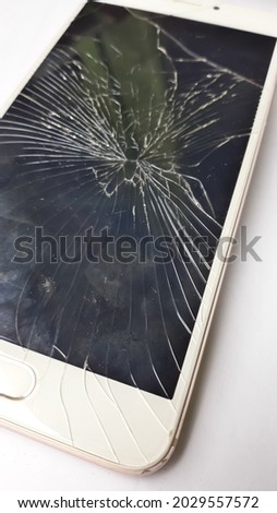 modern touchscreen smartphone with broken screen isolated on white background