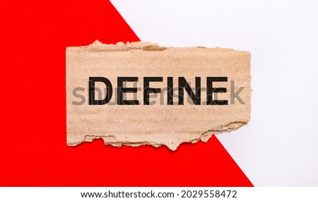 On a white and red background, brown torn cardboard with the text DEFINE