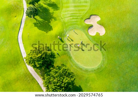 Golf course sport, green grass and trees on a golf field, fairway and putting green top view, Bangkok Thailand. bird view over Golf course in the tropical asia. Royalty-Free Stock Photo #2029574765