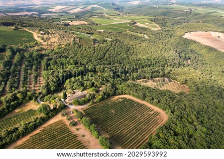 Landscape in Tuscany photographed with a drone. Fields, valley of Toscana, Siena region in Italy with roads, fields, forests and grape farms. Province of Siena Italy