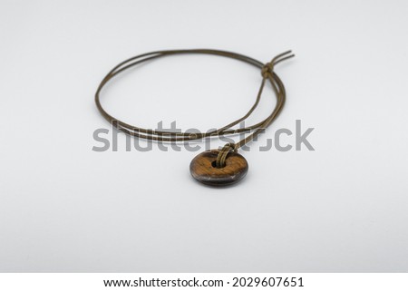 A Horizontal shot of a Necklace in two different position 
