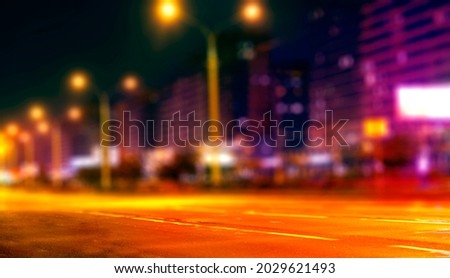 Blurred city background at night. City night lights in neon colors.