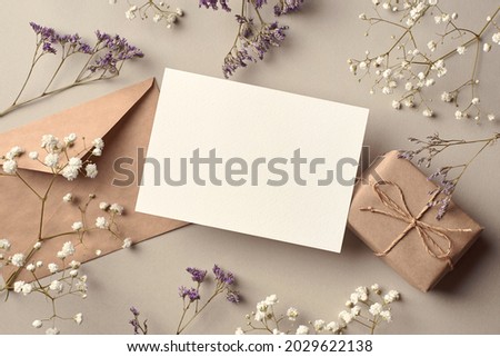 Invitation or greeting card mockup with gift box and dry flowers twigs, stylish top view mockup with copy space Royalty-Free Stock Photo #2029622138