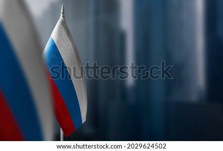 A small flag of Russia on the background of a blurred background Royalty-Free Stock Photo #2029624502