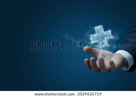 Business man hand showing virtual hologram of plus sign on blue background.
