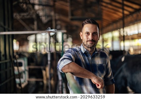Portrait of adult man, getting focused on his work, on the farm.