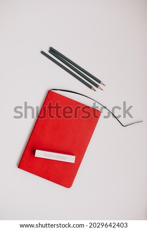 Back to school concept, school and office supplies, top view of notebook and pencils on white background