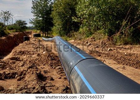 Civil engineering. The welded lash of the water pipe lies before installation Royalty-Free Stock Photo #2029660337