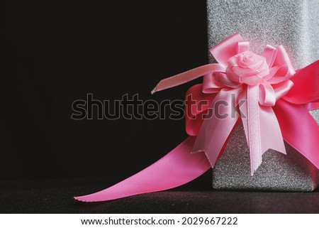 Valentine gift box placed on a black background.