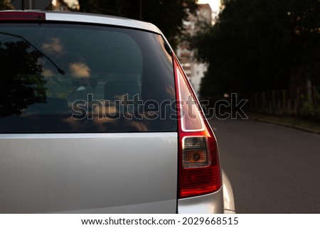 Back window of grey car parked on the street in summer sunny day, rear view. Mock-up for sticker or decals Royalty-Free Stock Photo #2029668515