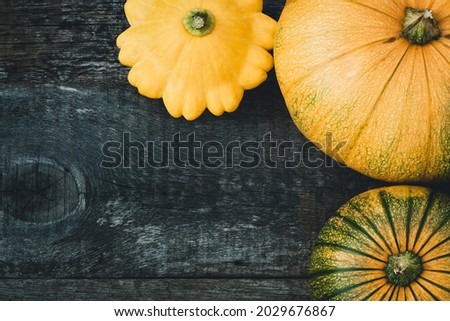 Pumpkins and peter pan squash on wooden background